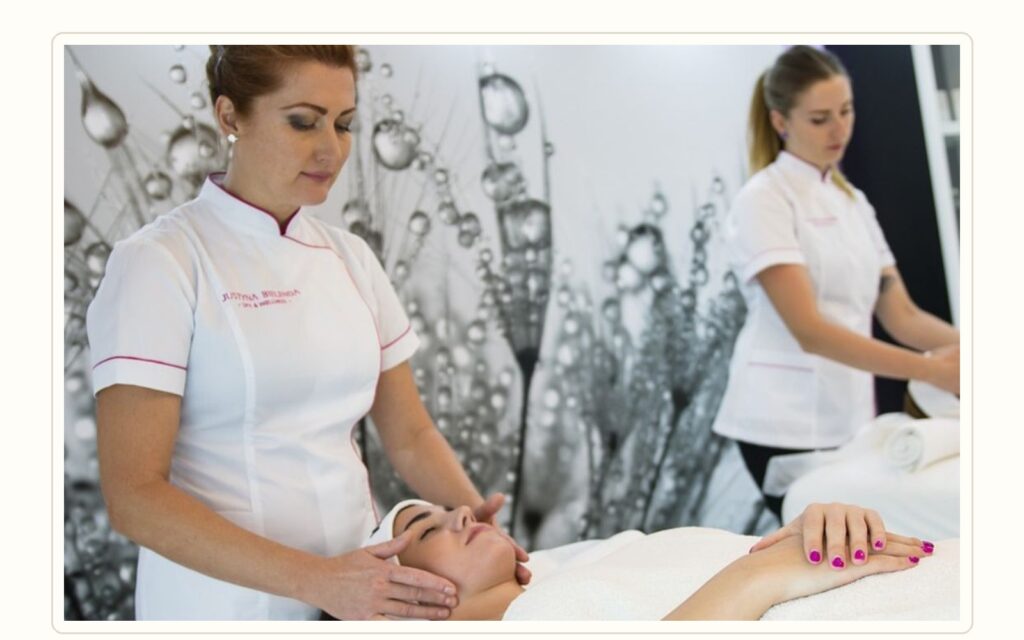 Massage therapist candidate completing a practical skills test in a professional spa room