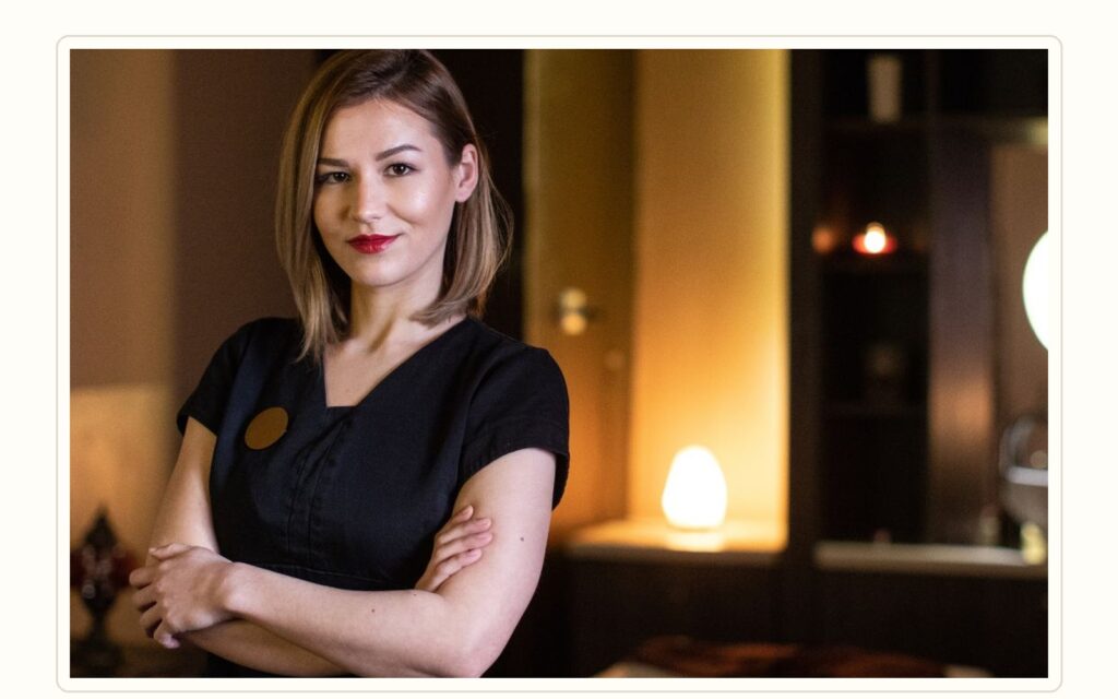 Spa manager reviewing massage therapist recruitment criteria in a premium wellness setting